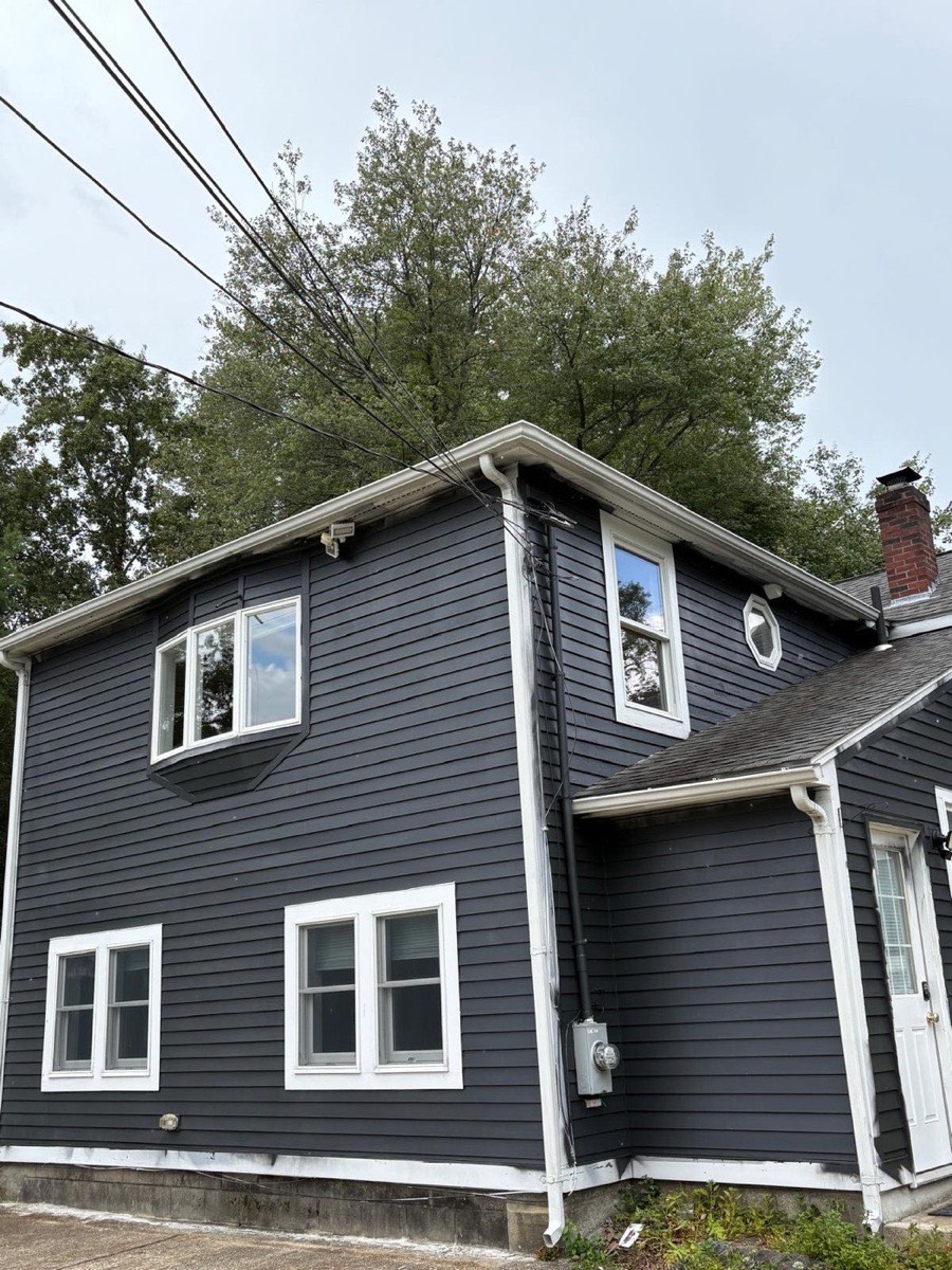 Colonial home freshly painted in deep navy by Nat Kay Painting