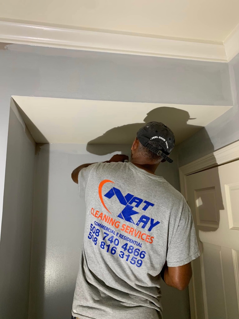 Kay from Nat Kay cutting in a ceiling line in a hallway