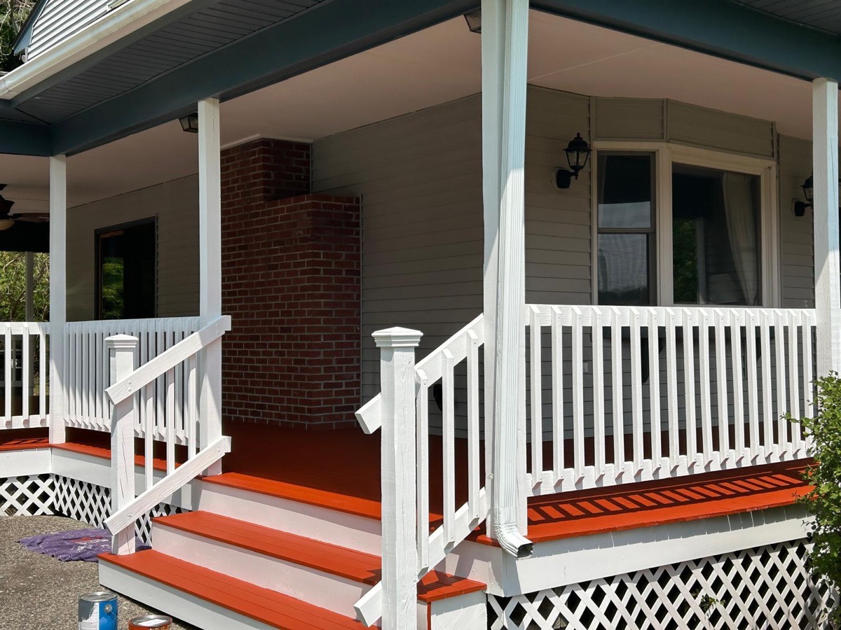 Porch steps painted red with white railings