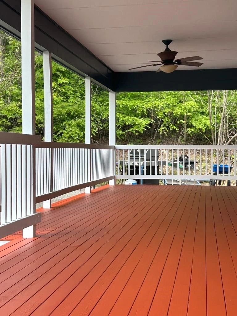 Freshly painted porch deck and white railings by Nat Kay Painting