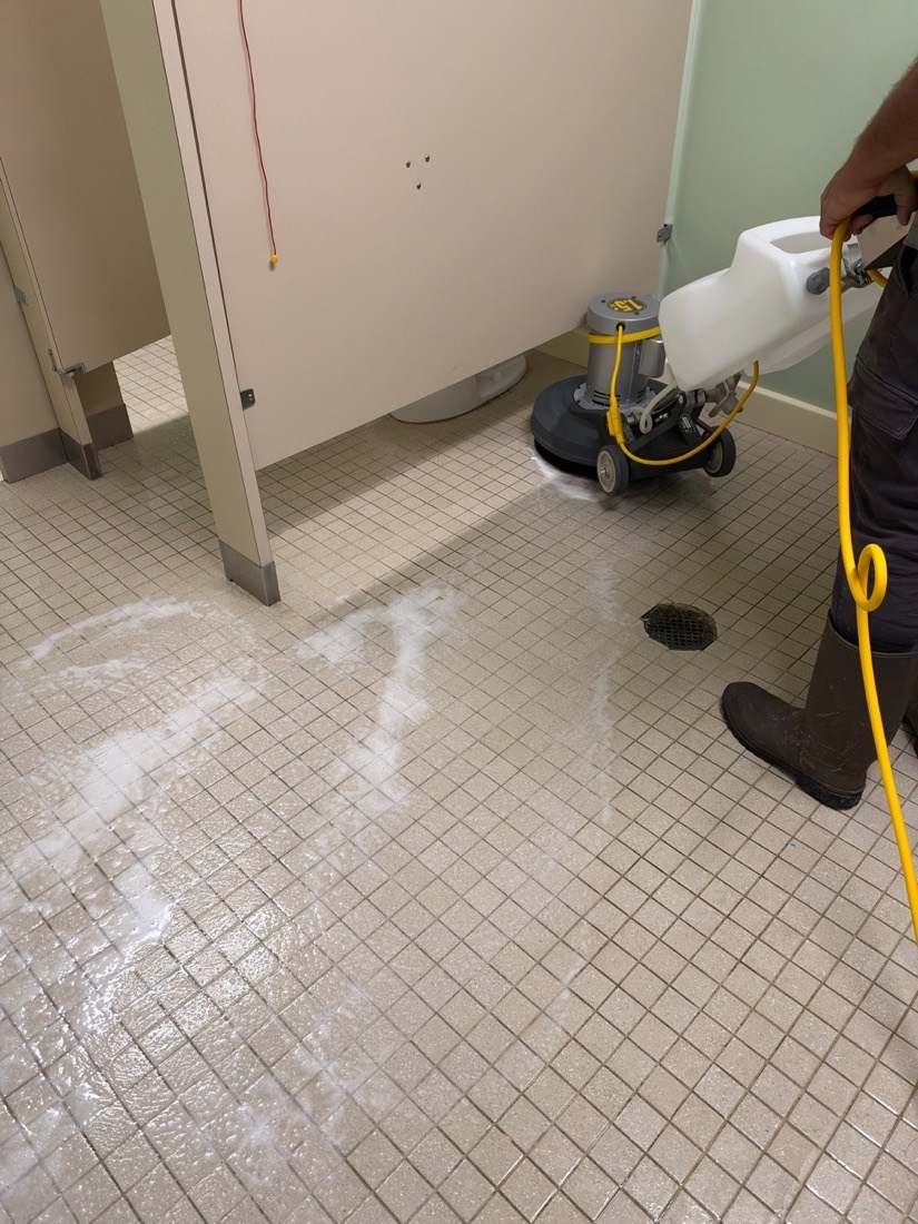 Restroom floor scrubbing with a professional machine